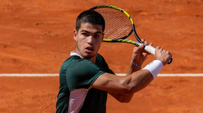 Spain’s Carlos Alcaraz returns the ball during a match against Spain's Rafael Nadal at the Mutua Madrid Open tennis tournament in Madrid.